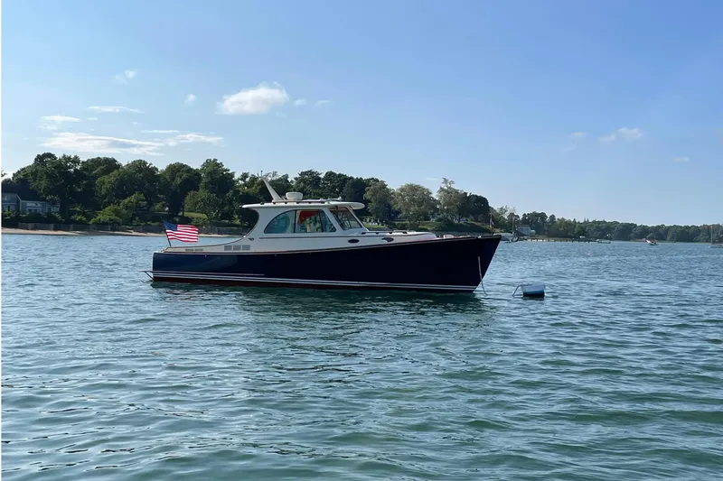 Slide: The Image of 2017 Hinckley Picnic Boat 37 MKIII on calm water under clear sky. - 6