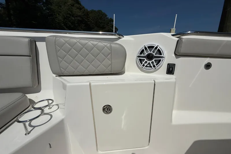 Slide: The Image of 2024 Pursuit S 328 Sport boat interior with speaker and cushioned seating. - 19