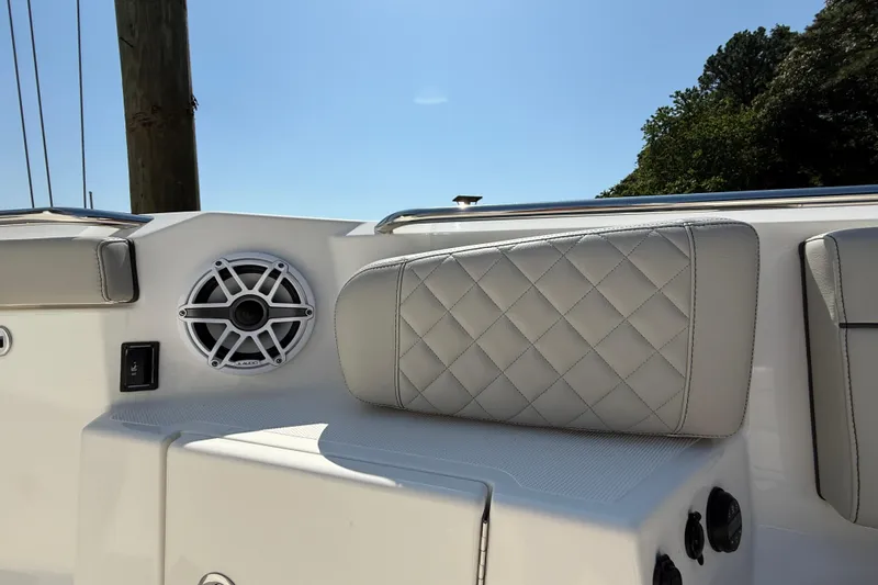 Slide: The Image of 2024 Pursuit S 328 Sport boat interior with speaker and cushioned seating. - 22