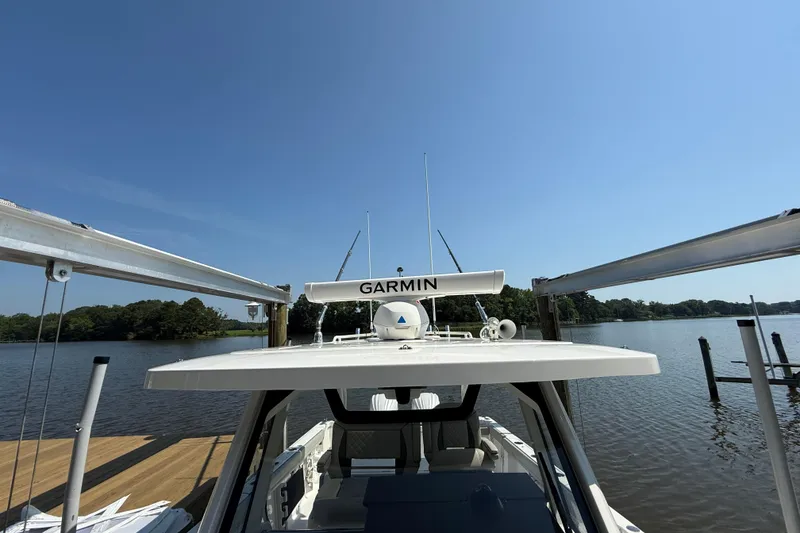 Slide: The Image of 2024 Pursuit S 328 Sport boat docked on a sunny day with Garmin equipment. - 26