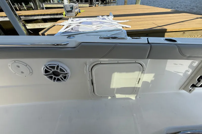 Slide: The Image of 2024 Pursuit S 328 Sport boat interior with speaker and storage compartment. - 30