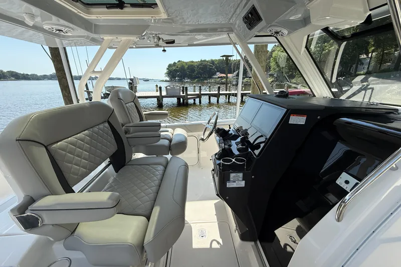 Slide: The Image of 2024 Pursuit S 328 Sport boat interior with luxurious seating and modern dashboard. - 32