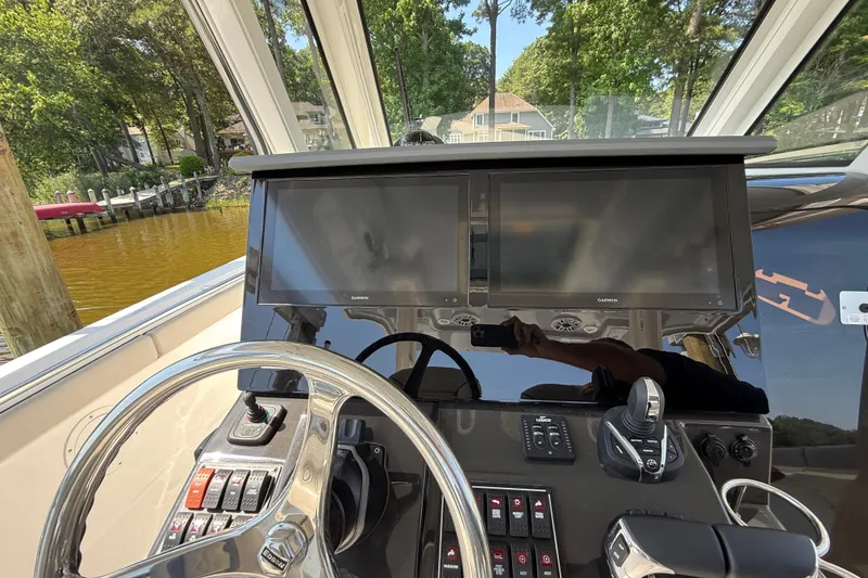 Slide: The Image of 2024 Pursuit S 328 Sport helm with dual Garmin displays and controls. - 34