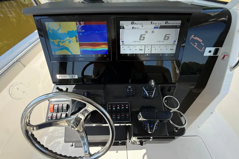 Slide: The Image of 2024 Pursuit S 328 Sport boat dashboard with navigation and control systems. - 35