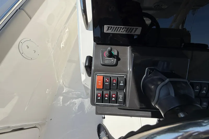 Slide: The Image of 2024 Pursuit S 328 Sport boat dashboard with control panel and steering wheel. - 39