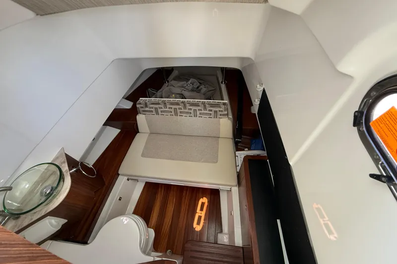 Slide: The Image of 2024 Pursuit S 328 Sport cabin interior with seating and wooden flooring. - 46