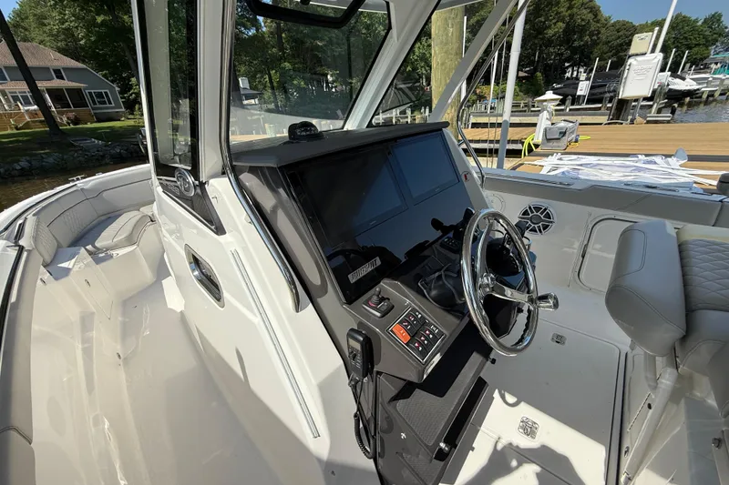 Slide: The Image of 2024 Pursuit S 328 Sport boat interior with modern helm and seating. - 50