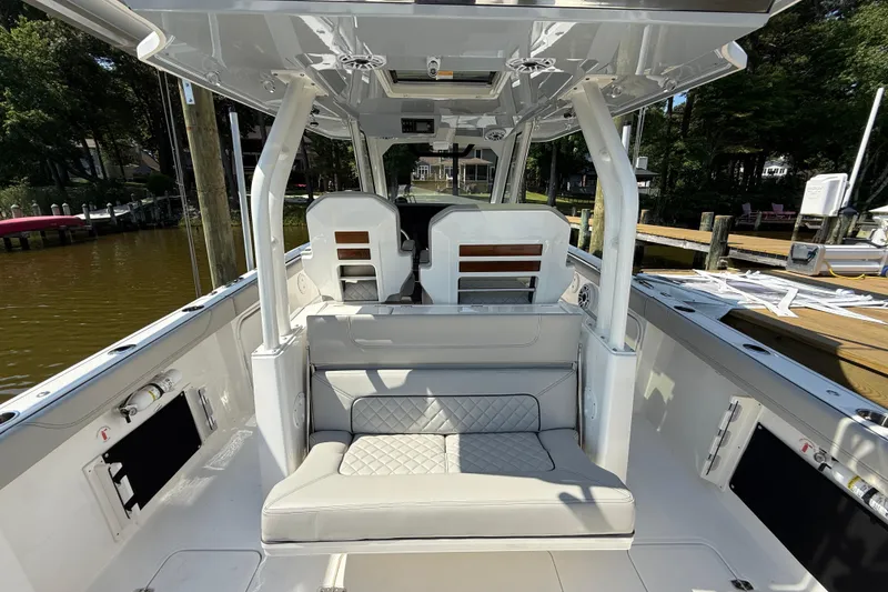 Slide: The Image of 2024 Pursuit S 328 Sport boat interior with cushioned seating and sleek design. - 55
