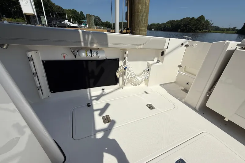 Slide: The Image of 2024 Pursuit S 328 Sport boat deck with storage and safety equipment. - 60
