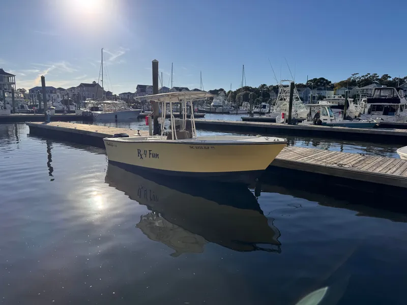 Slide: The Image of 1988 KenCraft Challenger 215 boat docked in a sunny marina setting. - 1