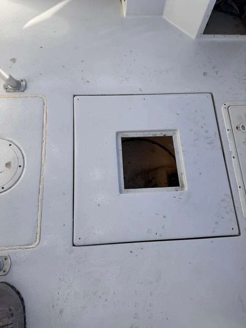 Slide: The Image of 1988 KenCraft Challenger 215 boat deck with open hatch, showing interior compartment. - 10