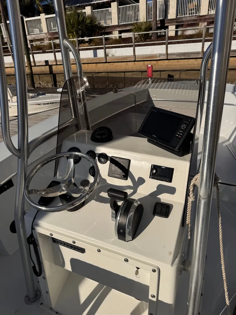 Slide: The Image of 1988 KenCraft Challenger 215 boat console with steering wheel and navigation equipment. - 6