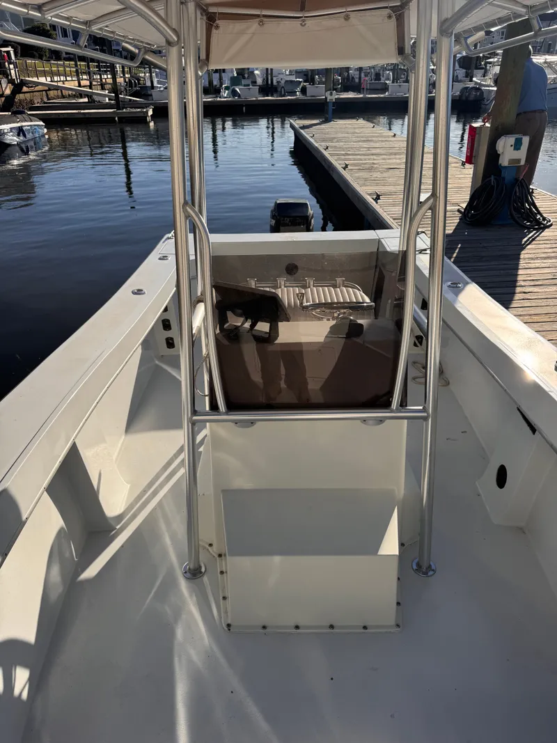 Slide: The Image of 1988 KenCraft Challenger 215 boat docked, featuring center console and T-top. - 7