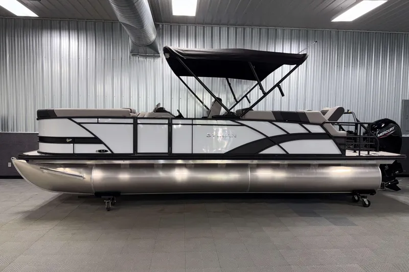 The Image of 2026 Sylvan L3 LZ pontoon boat in a showroom with sleek design and canopy. - 0