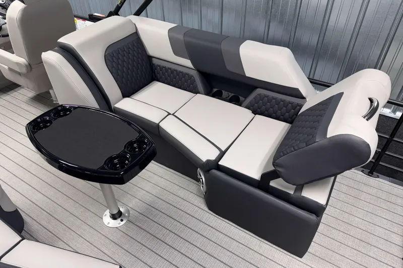 Slide: The Image of Luxurious seating on 2026 Sylvan L3 LZ pontoon boat with sleek table and cup holders. - 13
