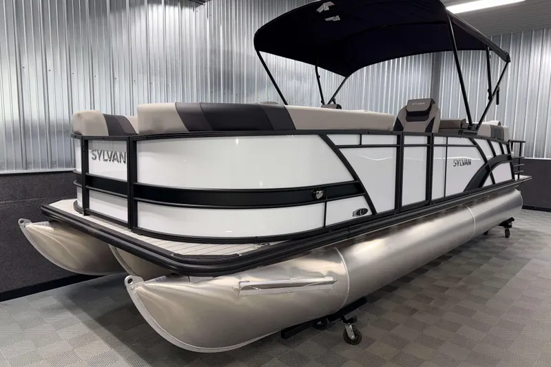 Slide: The Image of 2026 Sylvan L3 LZ pontoon boat with sleek design in a showroom setting. - 22