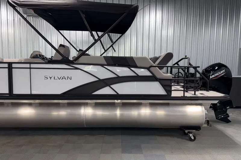 Slide: The Image of 2026 Sylvan L3 LZ pontoon boat with Mercury outboard motor in a showroom. - 26