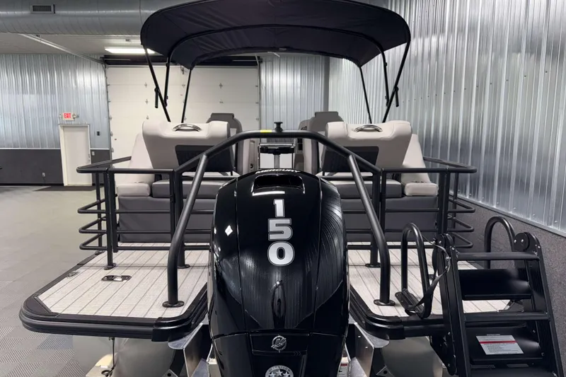Slide: The Image of 2026 Sylvan L3 LZ pontoon boat with 150 HP engine in a showroom. - 29