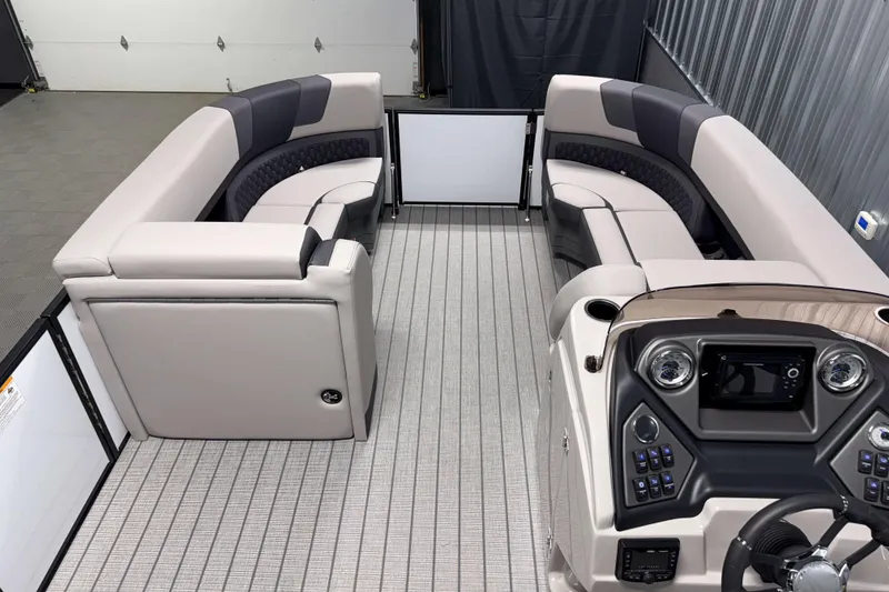 Slide: The Image of 2026 Sylvan L3 LZ pontoon boat interior with plush seating and modern dashboard controls. - 4