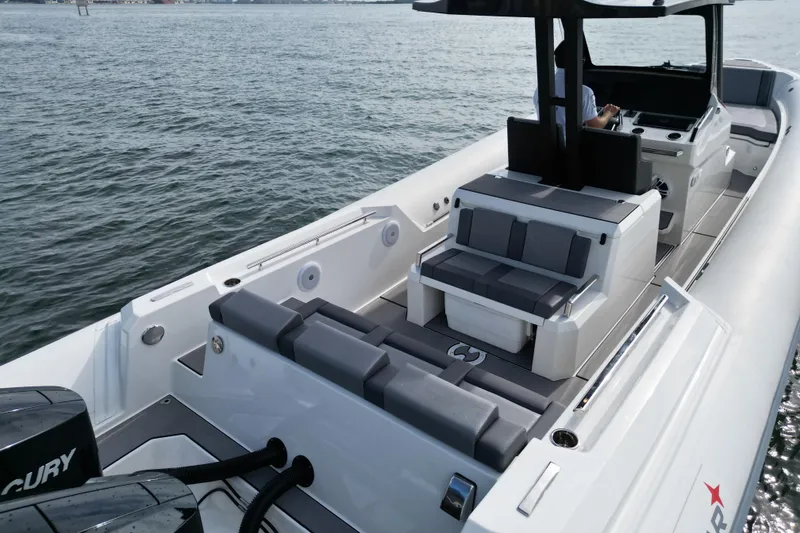 Slide: The Image of 2026 Northstar ORION 10 boat with sleek seating and dual Mercury engines on water. - 11