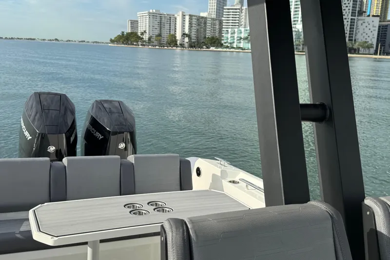 Slide: The Image of 2026 Northstar ORION 10 boat with dual Mercury engines on a calm waterfront. - 15