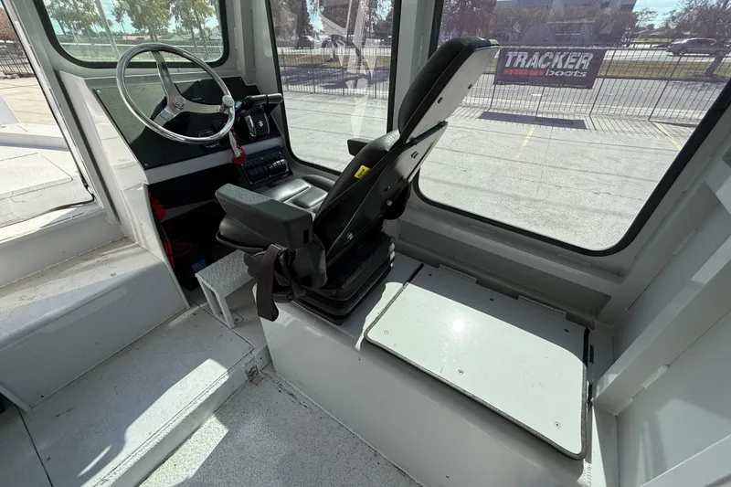 Slide: The Image of Interior of a 1996 Geo Marine 24ft Work Boat, featuring steering wheel and seating. - 14
