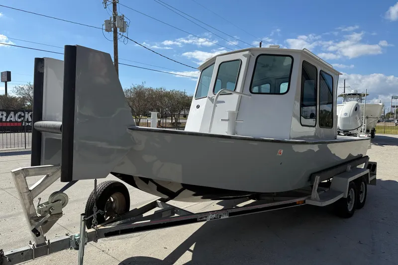 Slide: The Image of 1996 Geo Marine 24ft Work Boat on trailer under clear blue sky. - 4