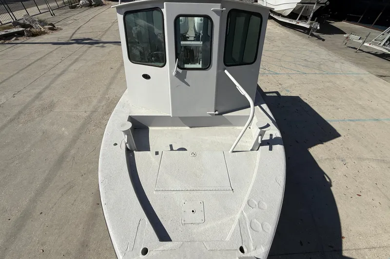 Slide: The Image of 1996 Geo Marine 24ft Work Boat with cabin, docked on concrete surface. - 9