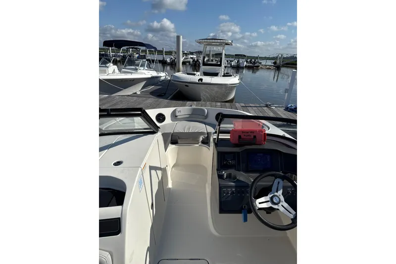 Slide: The Image of 2022 Bayliner VR6 Bowrider OB docked at marina under blue sky. - 5