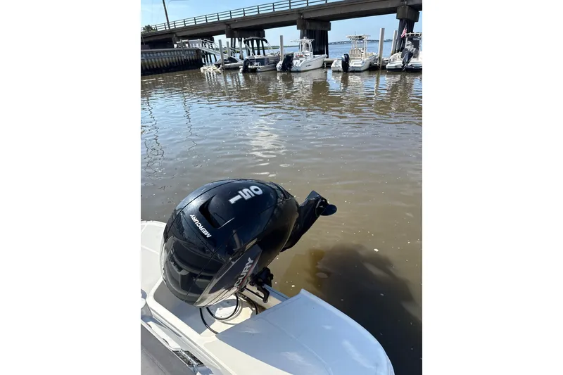 Slide: The Image of 2022 Bayliner VR6 Bowrider OB with Mercury outboard motor docked by a bridge. - 9