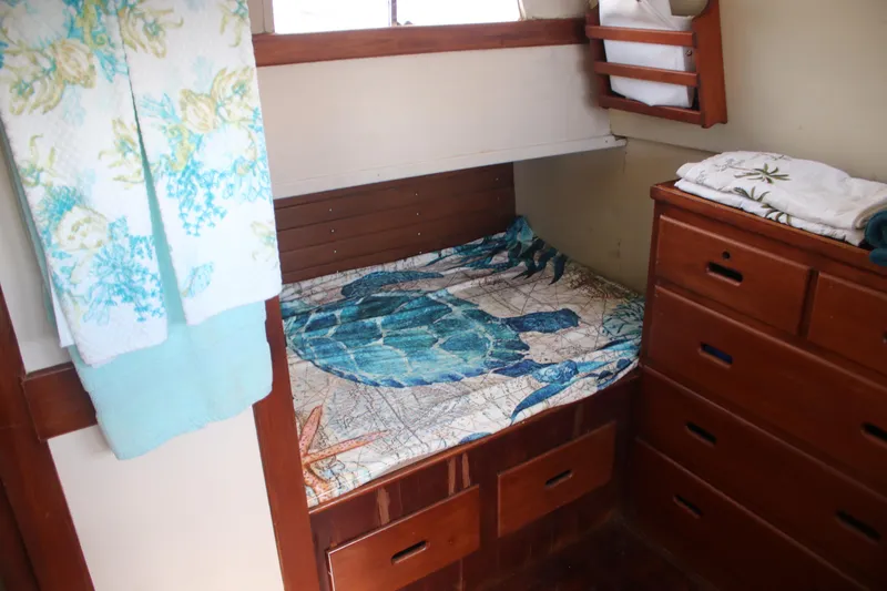 Slide: The Image of Cozy cabin interior of 1974 Grand Banks 42 Classic with nautical-themed bedding. - 11
