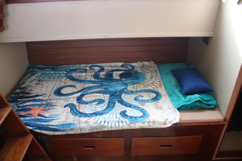 Slide: The Image of Cozy cabin bed in 1974 Grand Banks 42 Classic with octopus-themed bedding. - 12