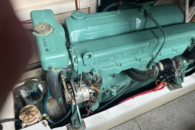 Slide: The Image of Engine of a 1974 Grand Banks 42 Classic boat, showcasing its mechanical components. - 15