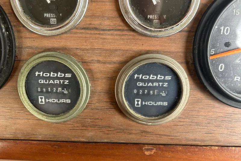 Slide: The Image of Close-up of Hobbs Quartz hour meters on a 1974 Grand Banks 42 Classic. - 16