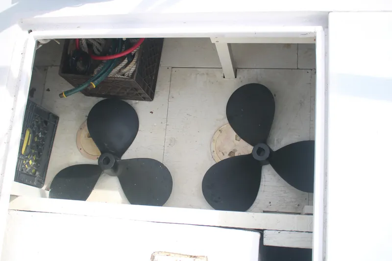 Slide: The Image of Storage compartment of a 1974 Grand Banks 42 Classic with propellers and ropes. - 22