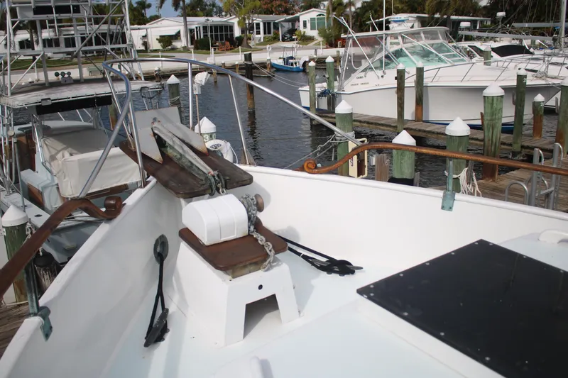 Slide: The Image of 1974 Grand Banks 42 Classic yacht docked at marina, showcasing bow and anchor. - 26