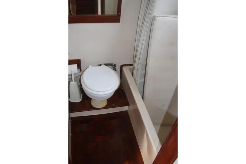 Slide: The Image of 1974 Grand Banks 42 Classic yacht bathroom with toilet and shower area. - 27