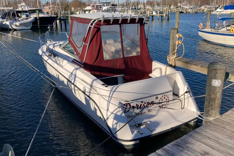 The Image of 1999 Chaparral Signature 29 boat docked at marina with red canopy. - 0