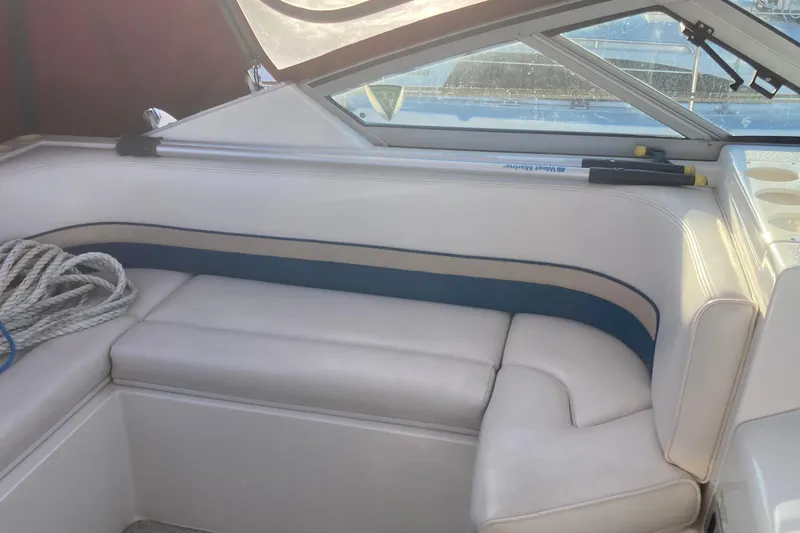 Slide: The Image of Interior seating of 1999 Chaparral Signature 29 boat with white upholstery and blue accents. - 10