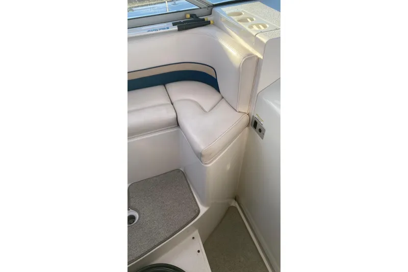Slide: The Image of Interior seating of 1999 Chaparral Signature 29 boat, featuring white and blue upholstery. - 11