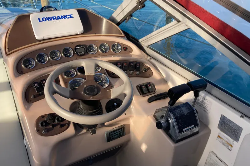 Slide: The Image of 1999 Chaparral Signature 29 boat dashboard with steering wheel and control panel. - 12