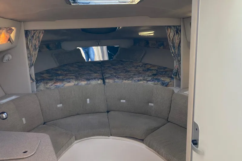 Slide: The Image of Interior of 1999 Chaparral Signature 29 boat with cozy seating and sleeping area. - 17