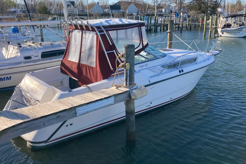 Slide: The Image of 1999 Chaparral Signature 29 boat docked in a marina with red canopy. - 2