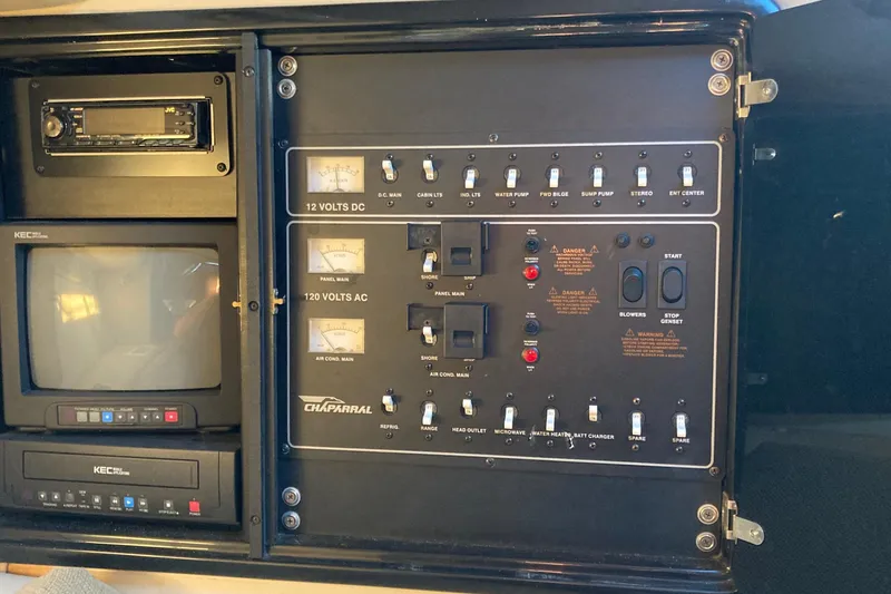 Slide: The Image of Electrical control panel of a 1999 Chaparral Signature 29 boat, featuring switches and meters. - 22