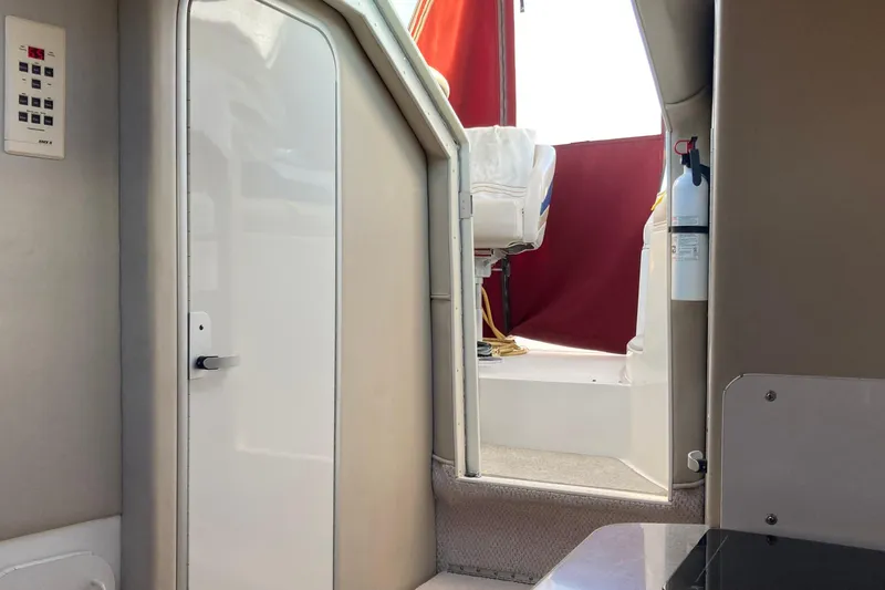Slide: The Image of Interior view of 1999 Chaparral Signature 29 boat, featuring cabin door and seating area. - 27