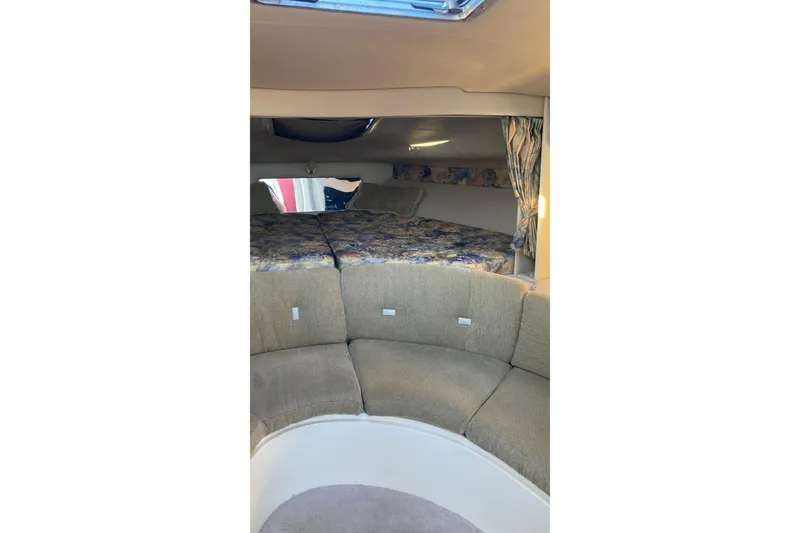 Slide: The Image of Interior of 1999 Chaparral Signature 29 boat with cozy seating and sleeping area. - 29