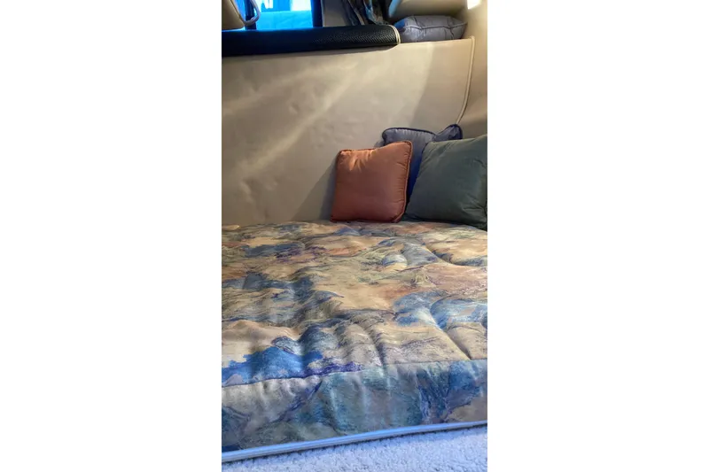 Slide: The Image of Interior cabin of 1999 Chaparral Signature 29 with colorful bedding and cushions. - 33