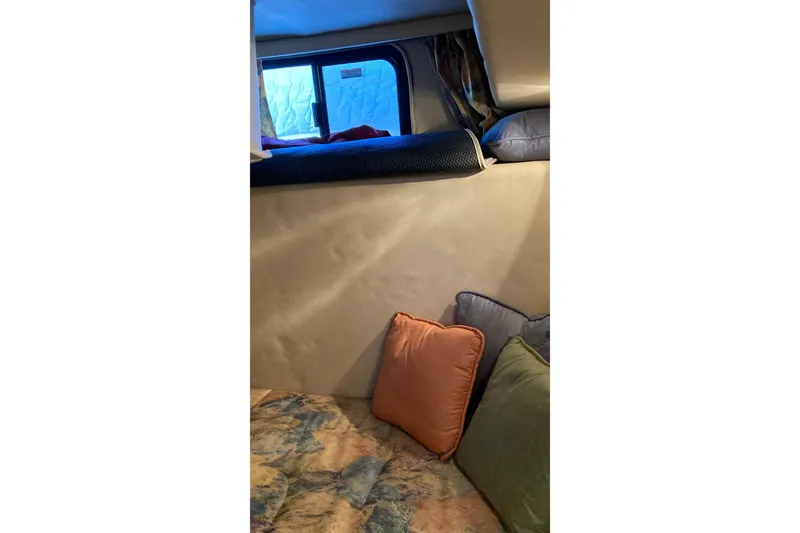 Slide: The Image of Interior cabin of 1999 Chaparral Signature 29 with cozy bedding and cushions. - 34