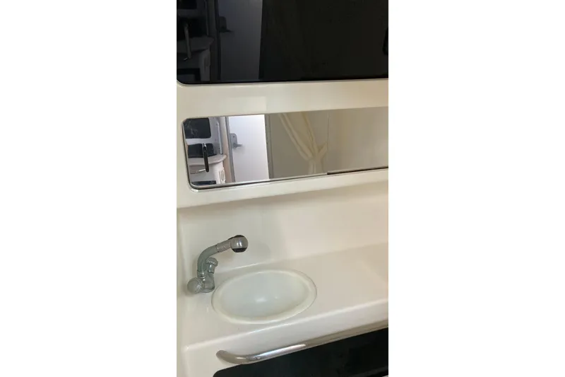 Slide: The Image of Bathroom sink and mirror in 1999 Chaparral Signature 29 boat. - 36