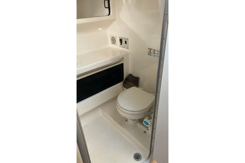 Slide: The Image of 1999 Chaparral Signature 29 boat bathroom with toilet and sink. - 37